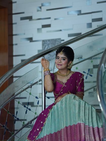 Nothing makes me happier than dressing sisters for their special moments. I designed these matching turquoise and purple Langa Voni outfits for a half saree function, ensuring they both looked coordinated yet unique.
