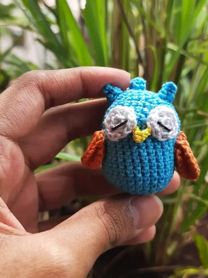 A sleepy little owl amigurumi. I used different shades of blue and orange to give it a unique look, and the closed eyes make it look so peaceful.