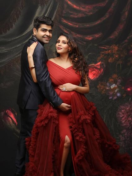 A moment of happiness and excitement. This couple portrait in a beautiful red gown against a painterly backdrop is full of romance and anticipation.