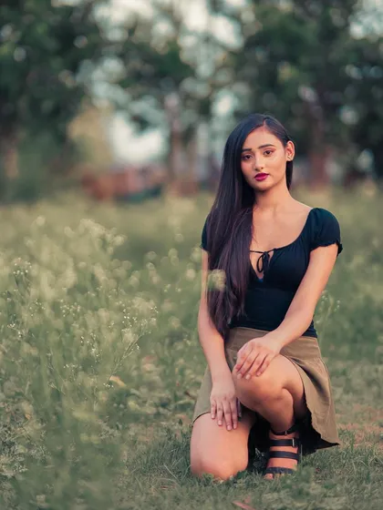 A clearer shot from the wildflower field, with a simple and direct pose. The soft, natural light is perfect for this kind of calm, beautiful portrait.