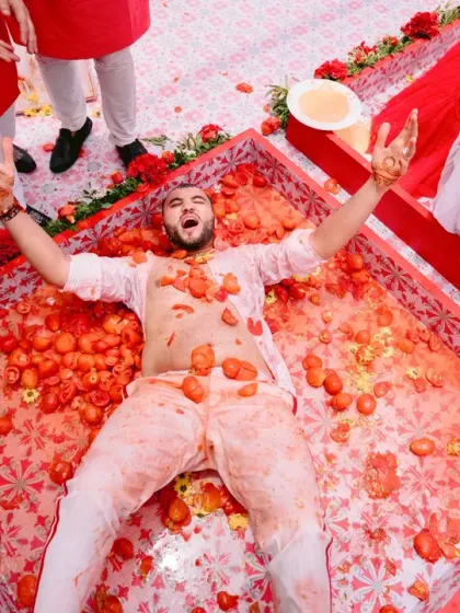 The groom gets the full 'La Tomatina' treatment during a wild and fun-filled pre-wedding celebration. A moment of absolute chaos and laughter.