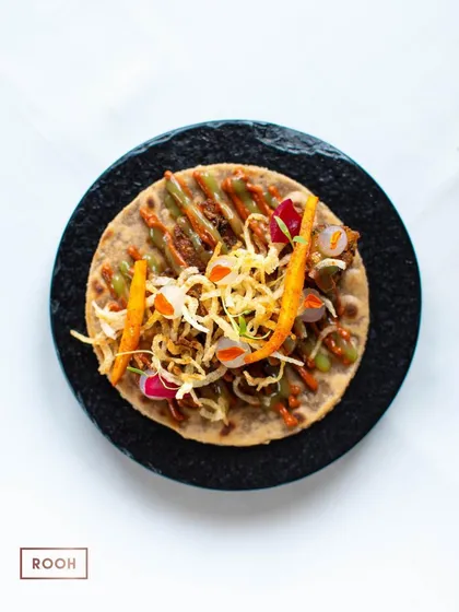 An overhead shot of the vegetarian taco, showcasing the vibrant colors and layers of ingredients. I design my dishes to be as beautiful as they are delicious.