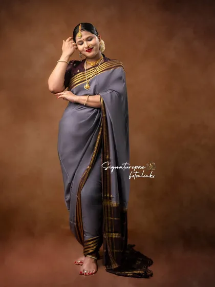 This pose adds a touch of shyness and grace, beautifully captured in the traditional setting.