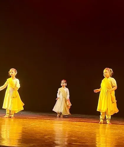 Another look at our little rockstars presenting a `vandana`. The discipline of standing in formation and performing together is a key skill learned in our group classes.