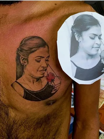 Creating a realistic portrait tattoo requires precision. Here, you can see the final tattoo on the client's chest placed next to the original reference photograph, showing how I accurately capture the likeness and emotion of the subject.