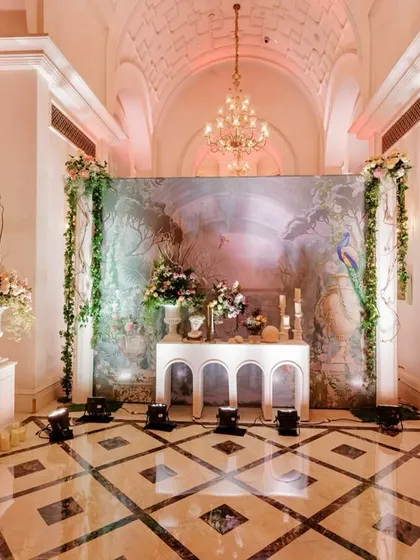 Another beautiful corner from the ring ceremony, where a painted backdrop, an elegant console table, and lush floral arrangements created a sophisticated and artistic vignette.