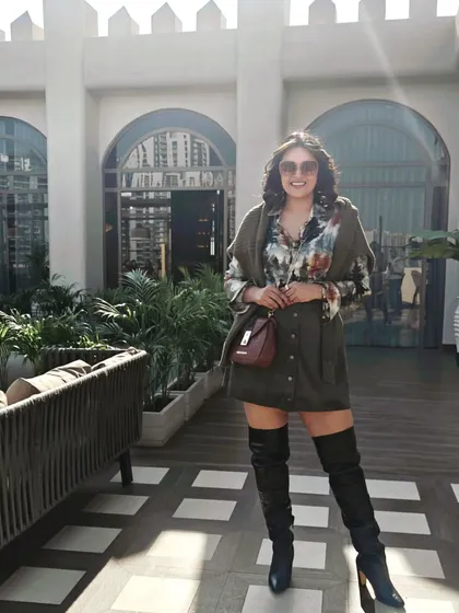 Thigh-high boots are always a statement. Here, I've paired them with a mini skirt and a printed shirt for a chic winter look.