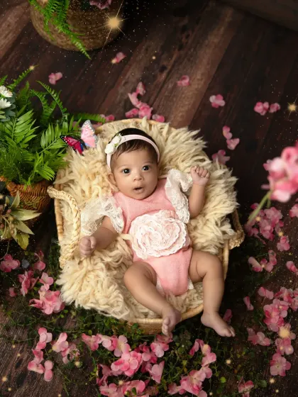 This awake shot captures the baby's curious expression as she looks up from her floral nest. The added sparkle effect gives it a magical touch.