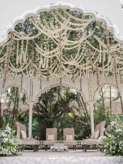 Ethereal florals, intricate details, and a mandap that feels like a dream. For this ivory-themed wedding, I used layers of white floral garlands to create a delicate yet grand canopy against a backdrop of lush greenery.