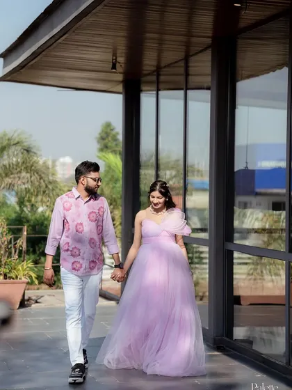 A full-length shot of the couple, showing the beautiful movement of the lavender gown. It's a perfect choice for an outdoor pre-wedding or maternity shoot.