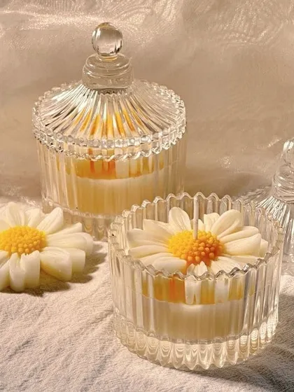 A closer look at our daisy candles in elegant crystal candy jars. They add a touch of class to any setting.