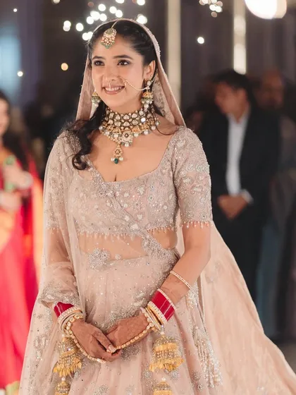 The bride's radiant smile as she enters. The makeup is fresh and enhances her happiness, ensuring she glows throughout the ceremony.