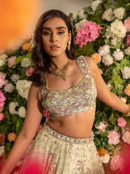 A close-up on the multi-colored pastel blouse, a unique and modern choice.