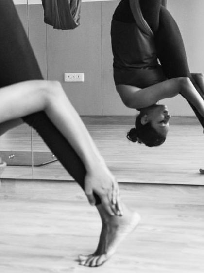 This artistic black and white shot captures the feeling of surrender in an inversion. It's a moment to let go, trust the hammock, and allow your body to release.