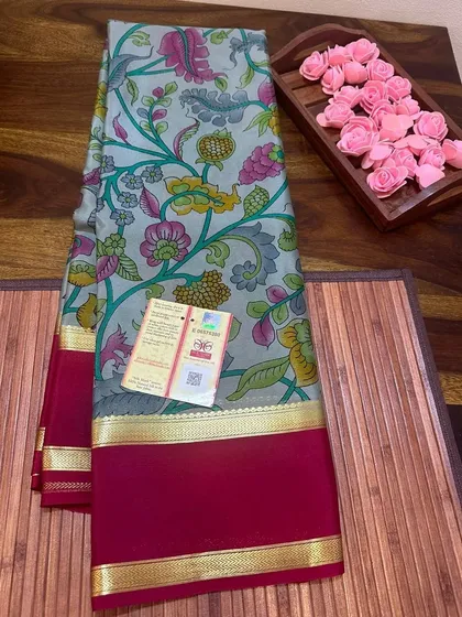 A subtle grey floral Kalamkari print on a Mysore silk saree with a maroon border.
