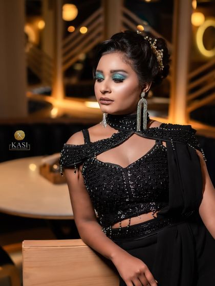 A full shot of the black outfit with colorful glittery eyes. This is a great look for a cocktail party or reception.