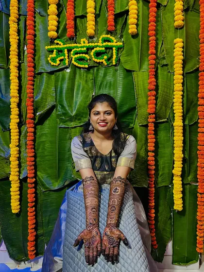 The bride proudly displaying her full bridal mehendi. The intricate patterns are a testament to the hours of artistry.