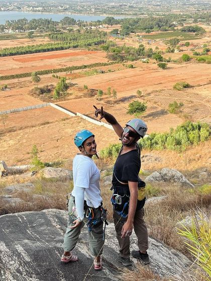 Gopika and a friend celebrating at the top of a climb. The sense of shared accomplishment is one of the best parts of climbing with a partner.