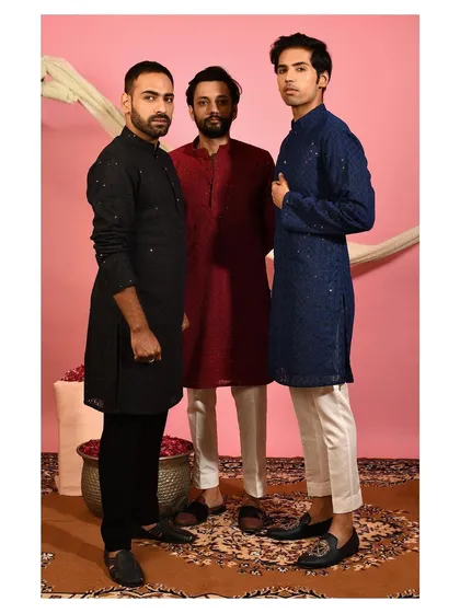 Here you can see a selection of my festive kurtas worn by the Sabre clan. This image showcases the variety of colors available, including classic black, deep maroon, and navy blue, each featuring my signature embroidery.