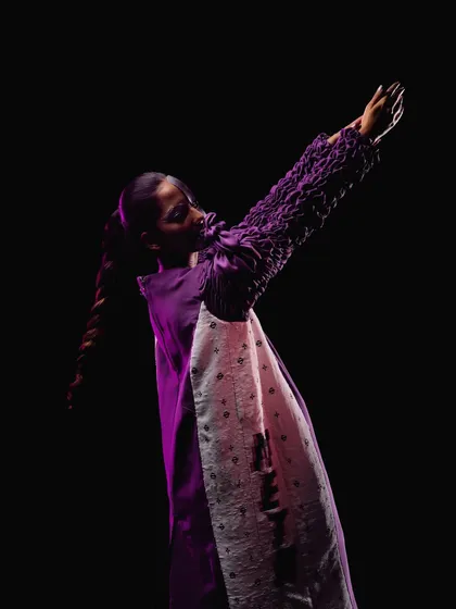 A wide shot capturing the full silhouette and the dramatic pose from the "Metaverse" editorial.