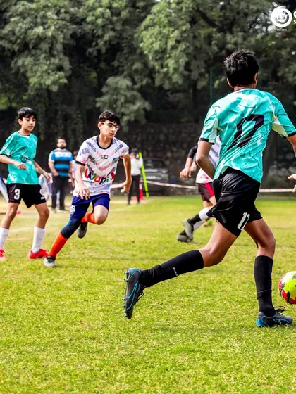 A player runs with the ball down the wing, looking to start an attack for his team.