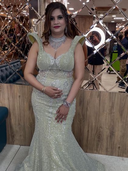 A full-length photo showing off the unique silhouette of the mermaid-style gown and how our styling completes the look.