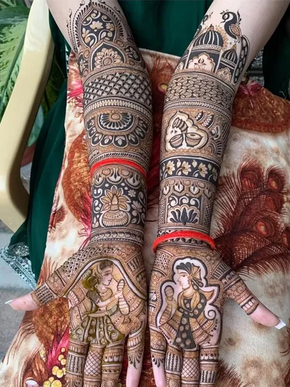 This full-arm design showcases a beautiful bride portrait on each palm, surrounded by traditional Rajasthani patterns and motifs, blending personalization with classic artistry.