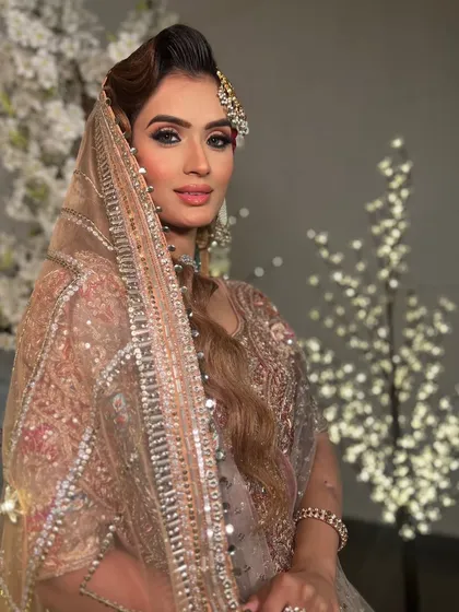 A soft, glowing bridal look. The makeup is kept minimal and elegant, with a focus on radiant skin and beautifully defined eyes.