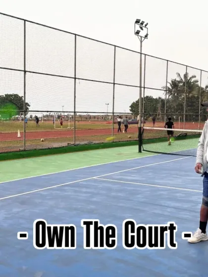 We teach our players to own the court. A coach feeds balls to a player, drilling him on returns and court coverage, building the stamina and confidence needed for competitive play.