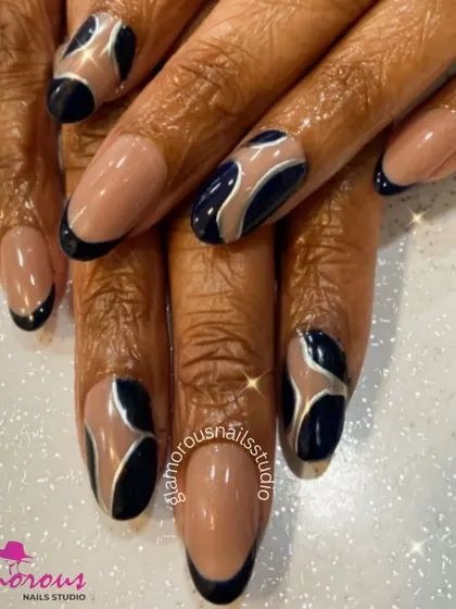 A sophisticated design using a nude base with black and silver abstract swirls. This look is perfect for someone who wants a modern, artistic design that remains elegant and neutral.