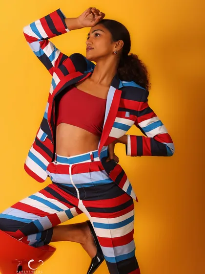A creative and dynamic pose using the stool as a prop. This shot is about movement, energy, and breaking the mold of static fashion photography.