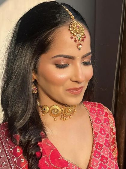 A close-up of the soft glam makeup for the Godh Bharai. The focus is on shimmery eyes and a flawless complexion, creating a look that is both elegant and joyful.