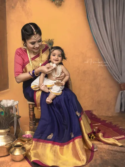 A sweet moment of feeding, echoing the stories of Yashoda and her beloved Krishna. It's these details that make the portraits so meaningful.