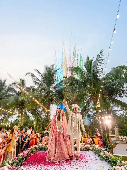 A wide shot of their victory pose, with colorful fireworks lighting up the sky behind them. A truly grand celebration.