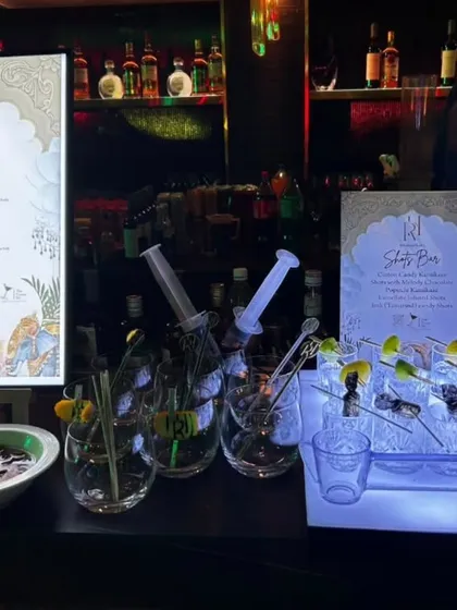 This setup features a custom-designed, illuminated menu alongside our unique 'Shots Bar'. The syringe-style shot dispensers add a fun, quirky element that gets guests talking.