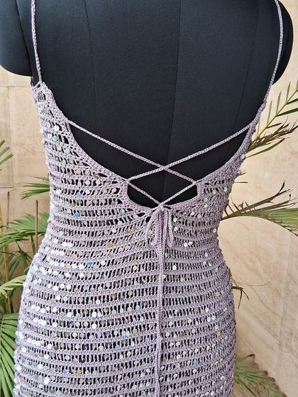 The back of the sequin cocktail dress, featuring an adjustable criss-cross tie. This detail ensures a perfect fit while adding a touch of allure.