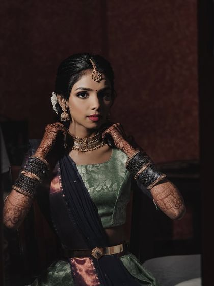 A moody, artistic shot of the bride. The makeup looks striking even in low light, showcasing its versatility.