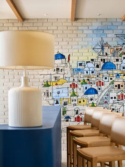 Design is found in the details that evoke a specific feeling or place. At the Godrej Woods Clubhouse, this vibrant mural and the simple, clean lines of the bar create a cheerful, Mediterranean-inspired corner. It shows how we use art and color to craft unique narratives and moods within a larger space.