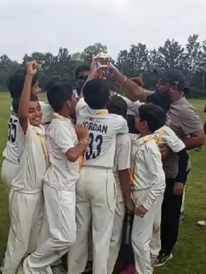 That championship feeling! Our U12 cricket team huddles together to lift the winner's trophy, a moment of pure celebration and team spirit after a successful tournament.