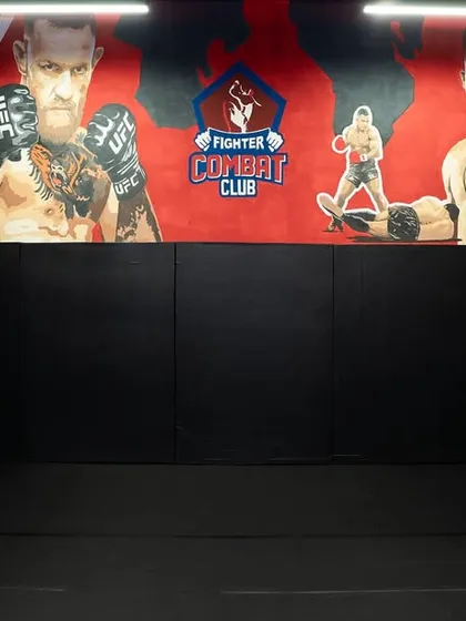 The heart of our gym, with heavy bags ready for your striking practice and the iconic FCC logo watching over you.
