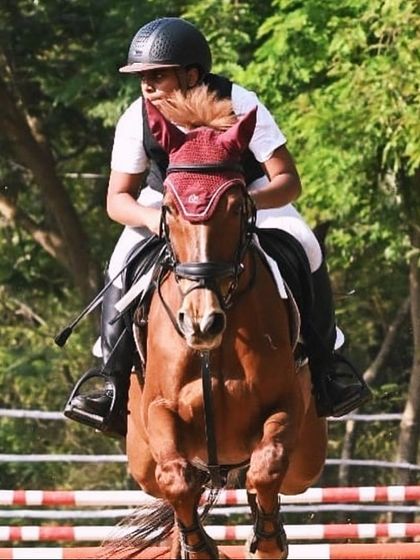 A young rider and his horse clear a jump during their first qualifying show in Pondicherry. I am proud to support my students as they begin their competitive careers.