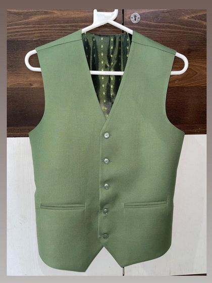 The matching light green waistcoat for the blazer shown earlier. Notice the quality of the buttons and the fine stitching around the pockets.