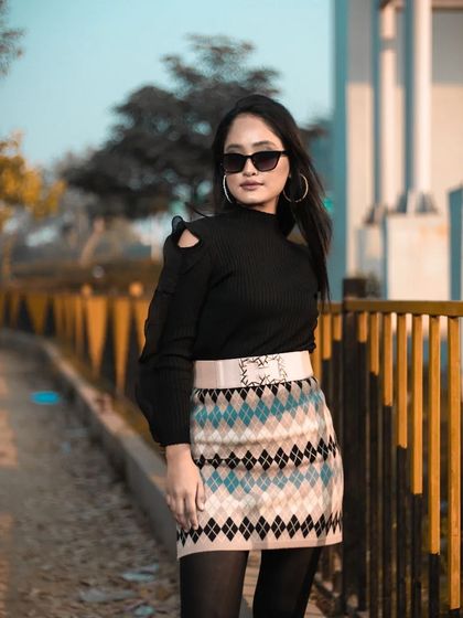 A full-body shot showing the complete winter outfit, from the sunglasses to the platform boots, with makeup to match.