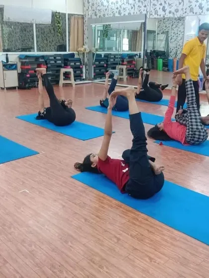 Students practicing a variation of a reclined leg stretch. In our group classes, we focus on foundational poses that build flexibility and body awareness for everyone.