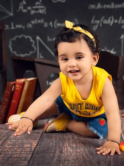 This little student is ready for "Study Time," crawling towards the camera with a big smile in her classroom-themed shoot.