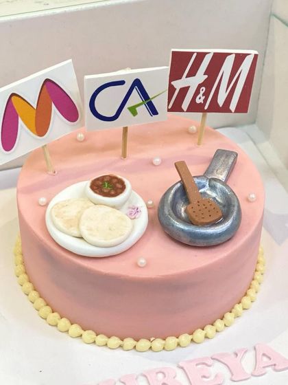 A cake that's all about your favorite things. This one was customized with logos for Myntra, H&M, and a CA emblem, plus favorite foods.