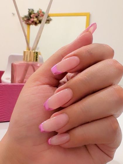 Another view of the vibrant pink chrome French tips, showing off their metallic shine.
