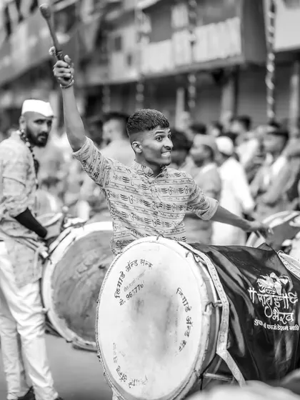 A monochrome take on the passionate dhol player, the black and white tones highlighting his intense focus and movement.