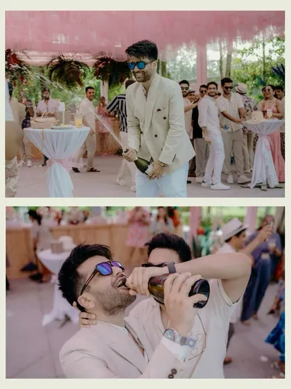 Capturing the fun and celebratory mood of the pool party. The groom pops a bottle of champagne and shares a laugh with his friends, showing the high-energy, candid side of the wedding events.