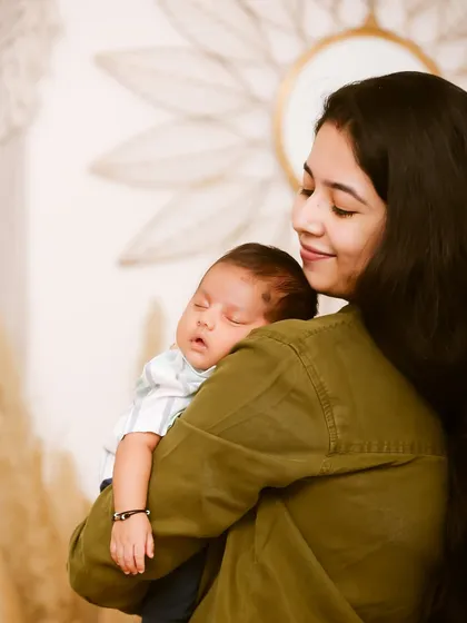 The simple, loving moments are often the most beautiful. A mother holding her sleeping newborn close is a timeless image of comfort and connection.